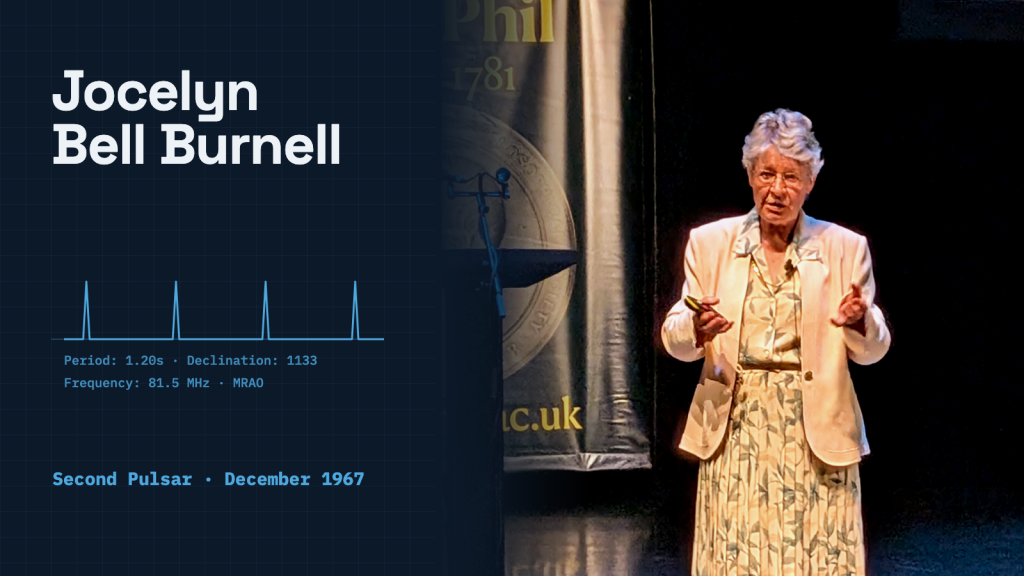 Jocelyn Bell Burnell speaking on stage against a dark backdrop in Manchester