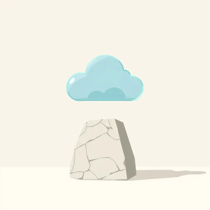 A geometric glass structure balanced on a polished stone block over a neutral background.